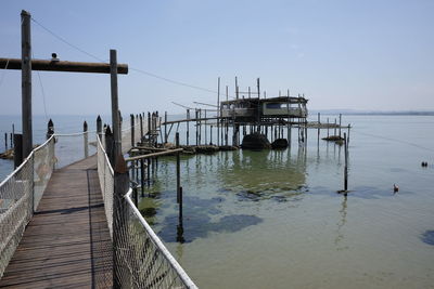 Pier on sea against clear sky