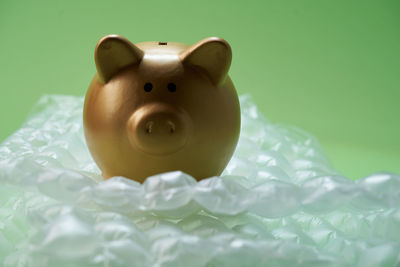 Close-up of a stuffed toy over green background