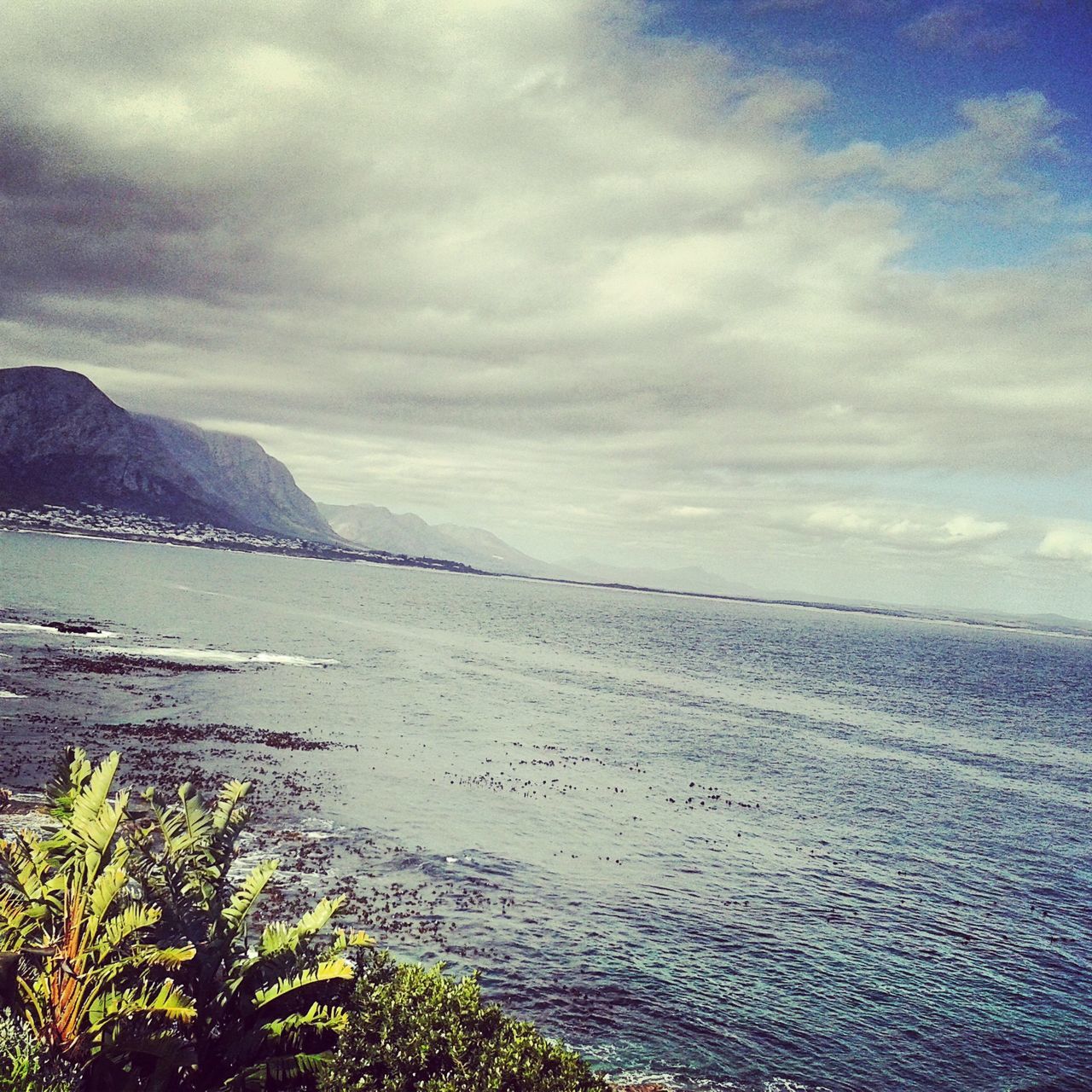 water, tranquil scene, sea, scenics, sky, tranquility, beauty in nature, cloud - sky, nature, beach, mountain, cloudy, idyllic, shore, cloud, horizon over water, coastline, non-urban scene, outdoors, remote