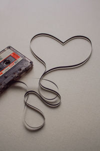 Heart shape made of audio cassette on white background