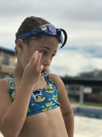 Cute girl wearing swimwear on poolside