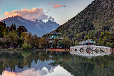 Scenic view of lake and mountains against sky