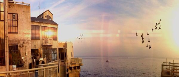 Reflection of built structures in water at sunset