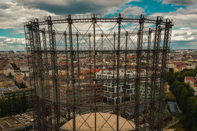 Ferris wheel by building against sky