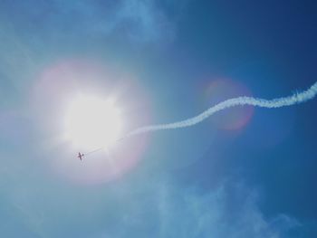 Low angle view of vapor trail against blue sky