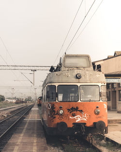Train at railroad station against clear sky