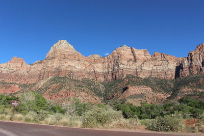 Scenic view of rocky mountains against clear blue sky