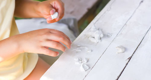 Kid hands in the process of creating the handicraft of polymer clay