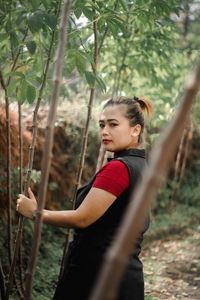 Portrait of young woman exercising in park