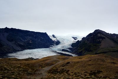 Scenic view of snow melting on mountains 