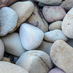 Close up of rounded and polished beach rocks on the sea shore