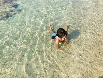 High angle view of boy on sand at beach