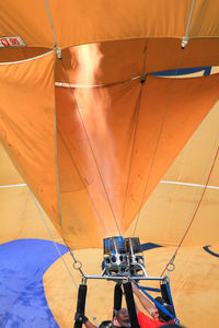 Low angle view of people and fire in hot air balloon