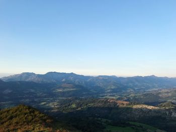 Scenic view of mountains against clear blue sky