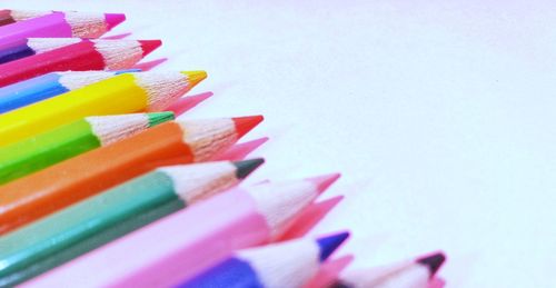 Close-up of colored pencils against white background