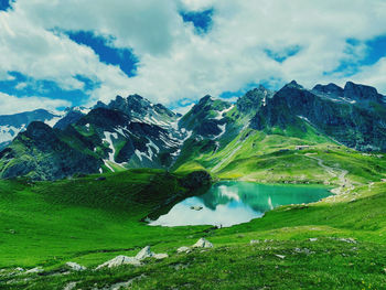 Scenic view of lake and mountains against sky