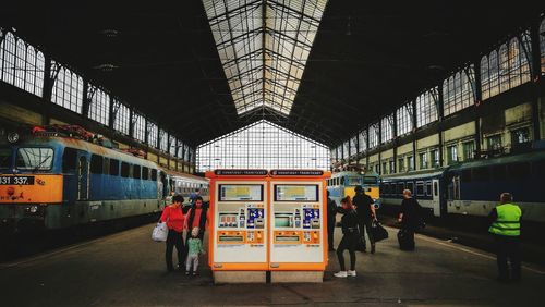 People waiting at railroad station platform