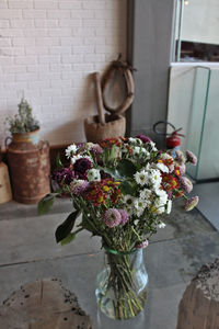 Flowers in vase against wall