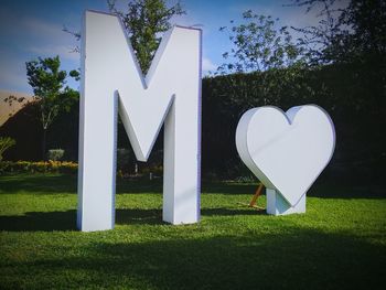 Heart shape on field by tree