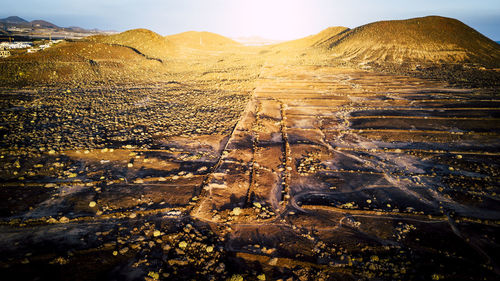 Aerial view of arid landscape against sky