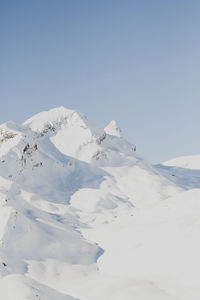 Scenic view of snow covered mountain against clear sky
