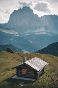 House on mountain against sky