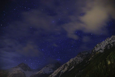 Low angle view of mountain against sky at night