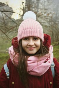 Portrait of smiling young woman in park during winter