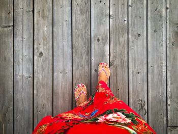 Low section of woman walking on wooden floor