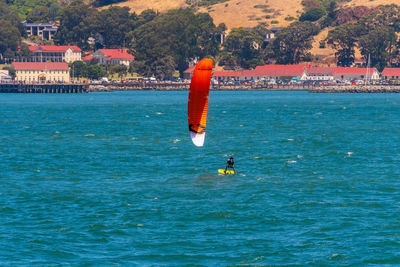 Person paragliding in sea