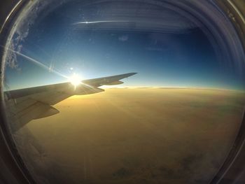 Cropped image of airplane flying over landscape