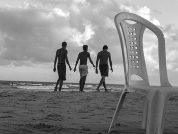 People on beach against sky