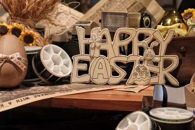 Happy easter text by egg on table