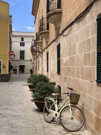 Bicycle on street amidst buildings in city