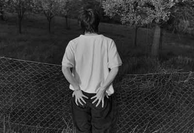 Woman standing on tree trunk