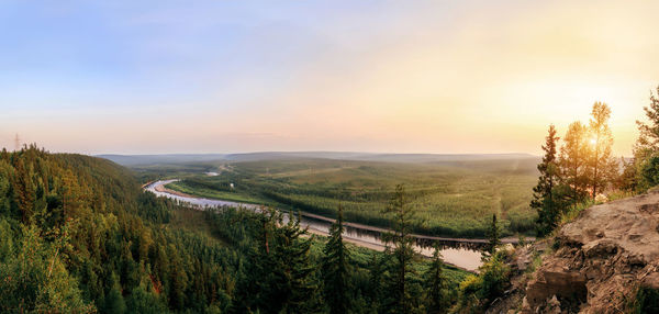 Panoramic view of river amidst trees against sky during sunset