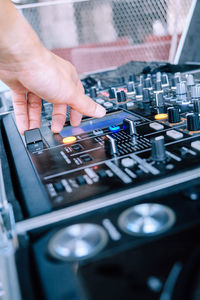 Close-up of cropped hand on control panel of turntable