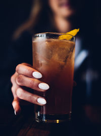 Midsection of woman holding drink