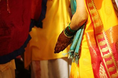 Close-up of man standing on yellow indoors