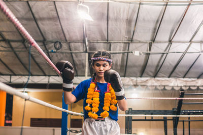 Woman standing in boxing ring