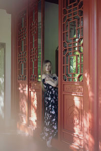 Portrait of woman standing on doorway