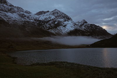 Scenic view of lake against sky during winter