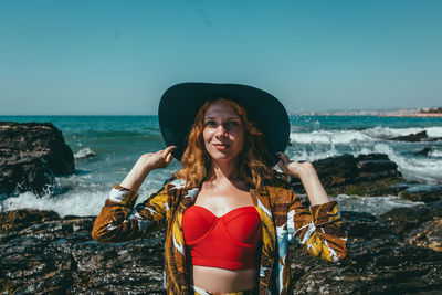 Portrait of fashionable woman standing on beach