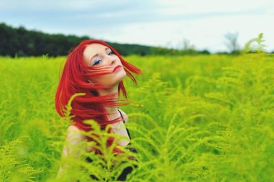 Portrait of girl standing on grassy field