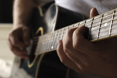 Cropped hand playing guitar