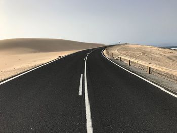 Empty road along countryside landscape