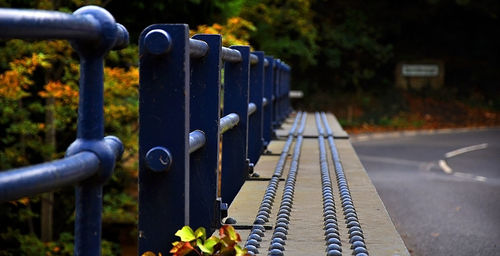 Close-up of metal fence by road