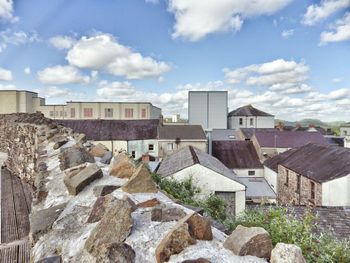 Houses against cloudy sky