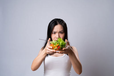 Portrait of young man eating food