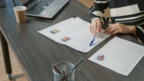 Midsection of business colleagues working on table